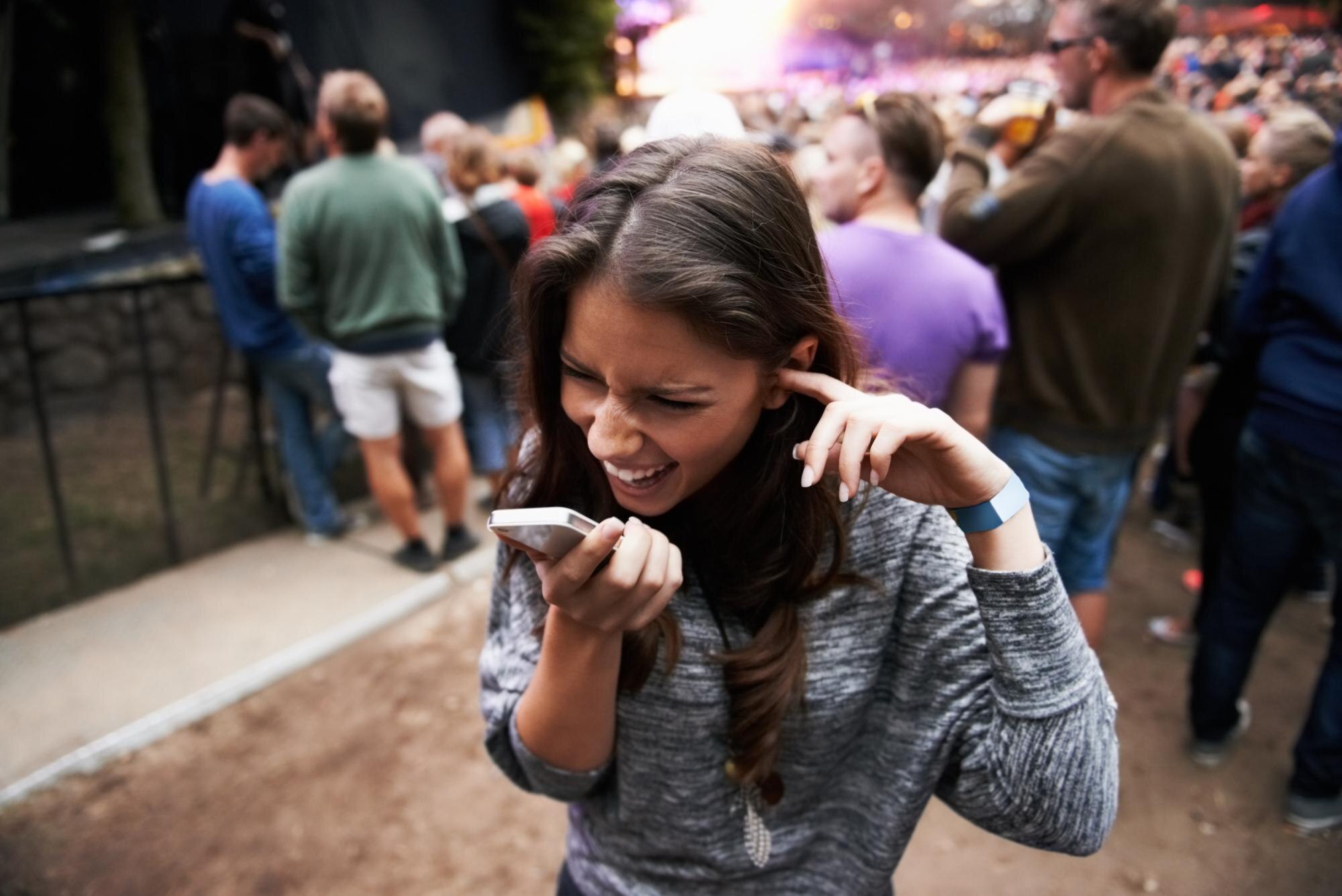 music festival event woman outdoor with phone call conversation noise from concert crowd party conta